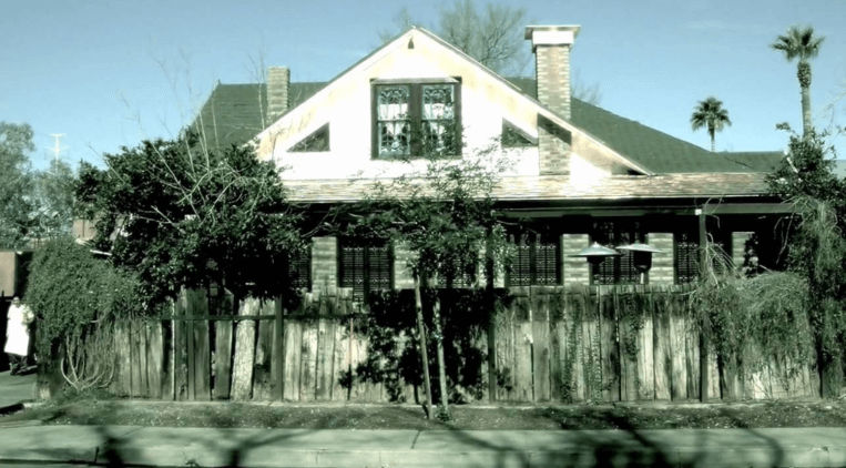 A house with a tree in front of it.